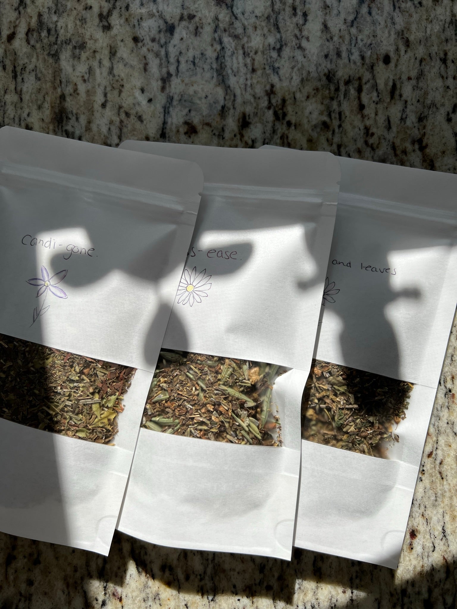 Tea pouches laying on a counter in sunlight