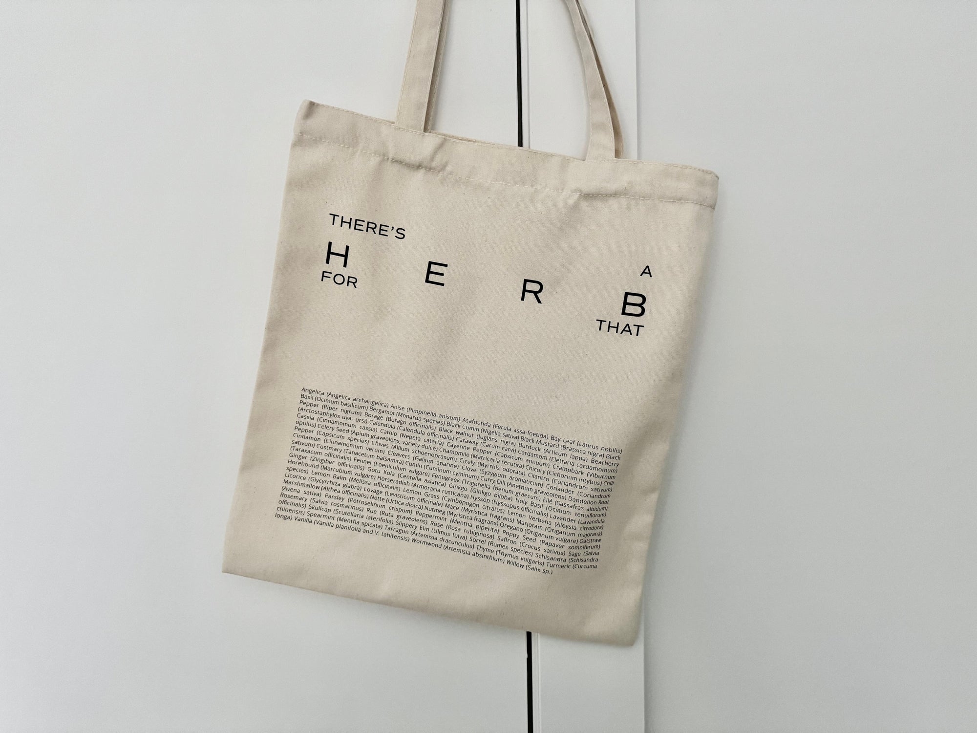 Tote bag hanging on a door saying "there's an herb for that"