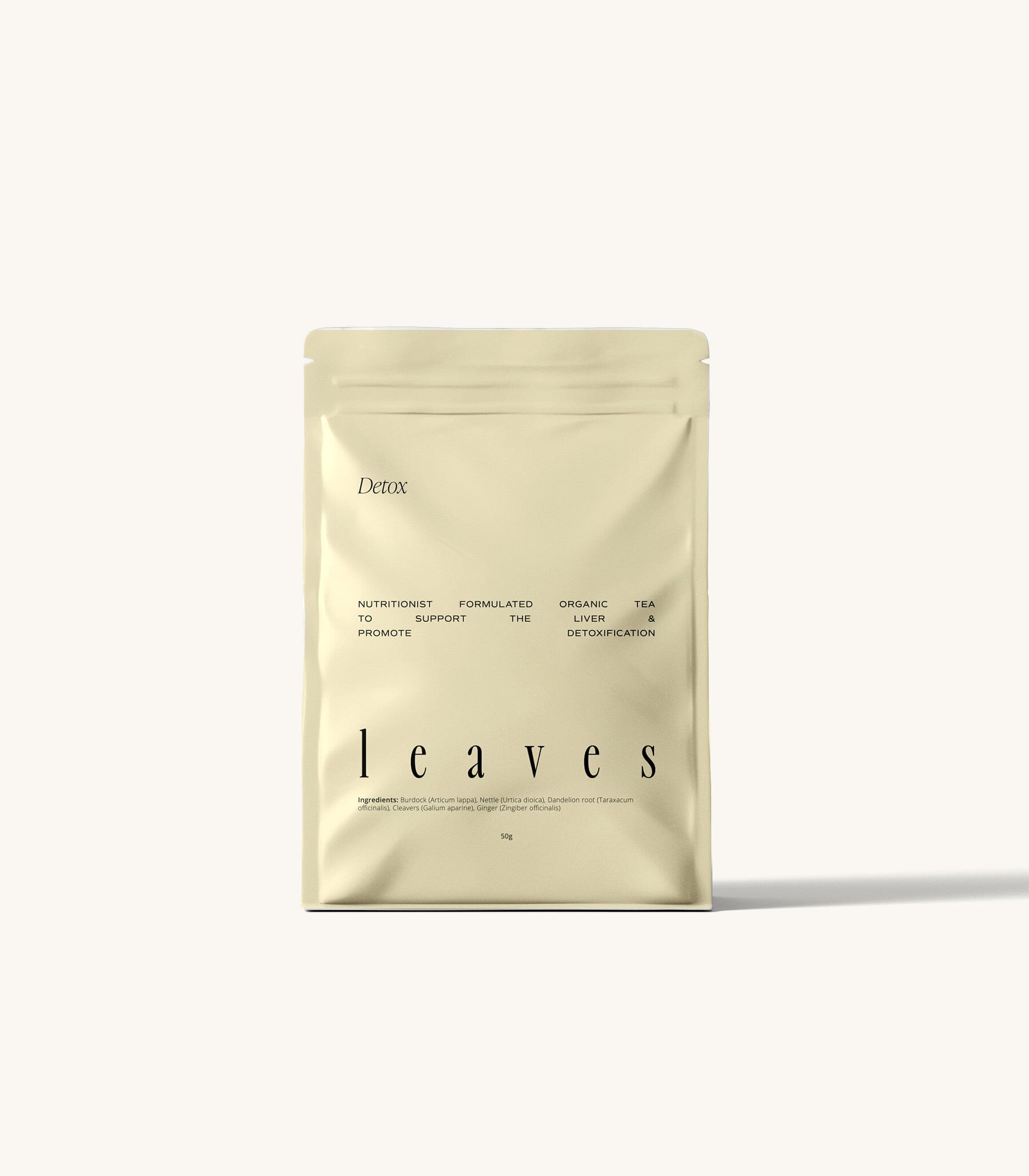 Detox tea pouch standing on a cream background 